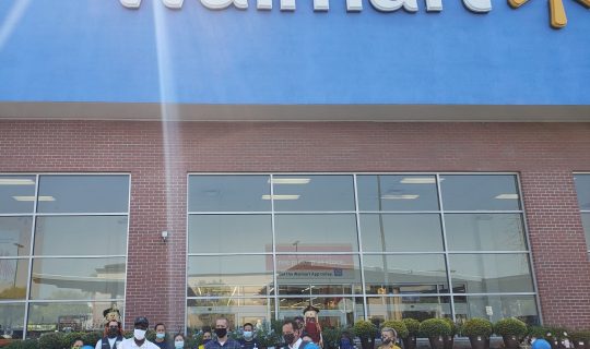 Council President Tony Johnson, front left, and Walmart’s Art Gladue, front right, donate gift cards to Sailors on the Bonhomme Richard.