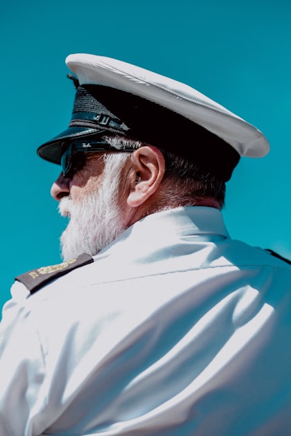 Senior naval captain in a white uniform and officer cap