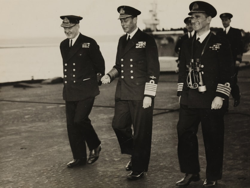 Vintage photo of King George VI and naval officers on a battleship deck