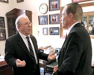 Two men talking in an office.